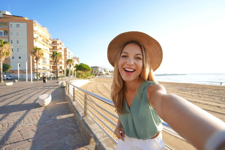 photo of  view of Holidays in Calabria. Selfie girl on Crotone promenade in Calabria, southern Italy.