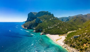 Photo of aerial view of Pittulongu, White Beach in Olbia, blue water, amazing Vegetation and sandy beaches with Tavolara island view, Italy.