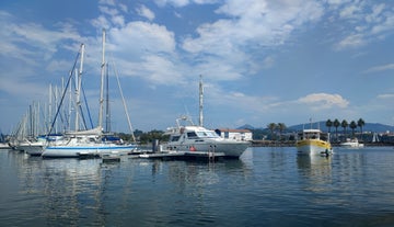 Photo of cityscape of French border town Hendaye, as seen from Spanish Hondarribia, with Famous Rhune Mount at Background, France.