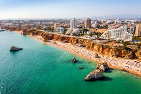 Photo of Carvoeiro fishing village with beautiful beach and colourful houses, Portugal.