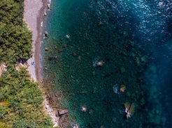 Photo of aerial view Nerano village, Infrastructure of a small town in the south of Italy, old houses, tight construction, mountain and sea in the background.