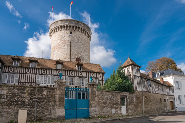 Photo of Old timber-framed houses and the ruin of the medieval fortification in the village Vernon, Upper Normandy, France.