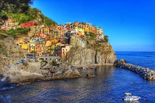 Photo of Riomaggiore with colorful houses along the coastline, one of the five famous coastal village in the Cinque Terre National Park, Liguria, Italy.