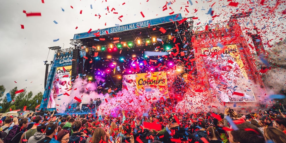 Crowd celebrating with confetti and lights at Colours of Ostrava music festival, a major summer event in Czechia in July..jpg