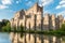 Photo of the historic city of Ghent with famous medieval Gravensteen Castle on a beautiful sunny day with blue sky and clouds in summer, Belgium.