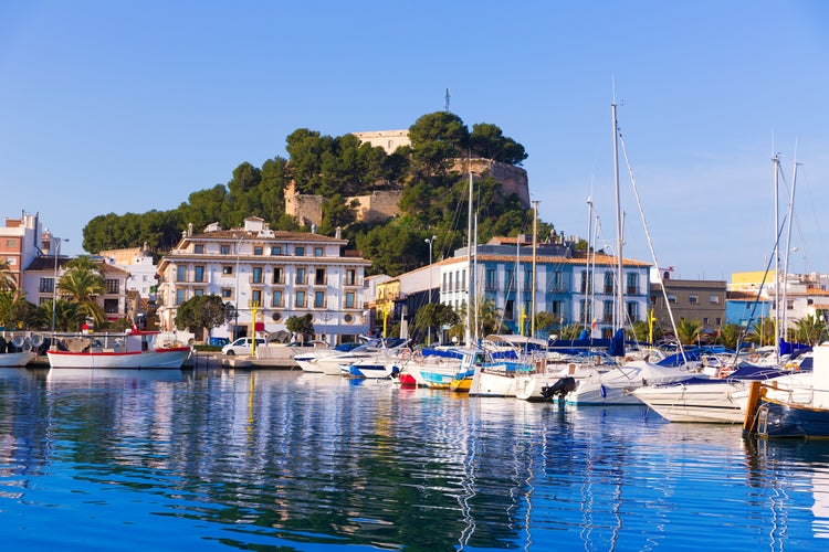 Denia Port with castle hill and marina boats in Alicante province Spain