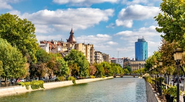 Antique building view in Old Town Bucharest city - capital of Romania and Dambrovita river. Bucharest, Romania, Europe.