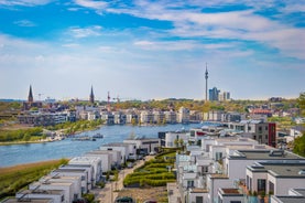 Cologne Aerial view with trains move on a bridge over the Rhine River on which cargo barges and passenger ships ply. Majestic Cologne Cathedral in the background.