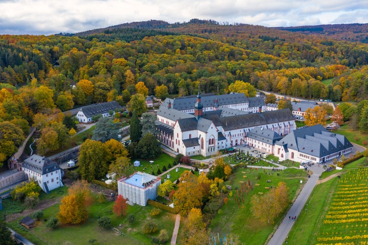 Photo of Bird's eye view of Eberbach Monastery near Kiedrich / Germany in the Rheingau with autumnal colored forest.