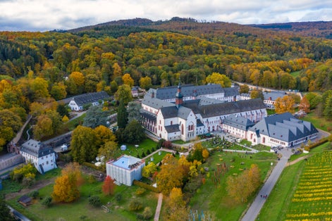 Photo of Bird's eye view of Eberbach Monastery near Kiedrich / Germany in the Rheingau with autumnal colored forest.