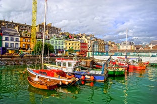  Cork, Ireland. Fishing boats inside the port of Cobh. A city with colorful houses in Ireland.