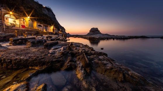 Passetto beach with typical fisherman caves in Ancona - Marche - Italy, at sunset