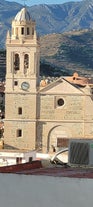 photo of Almuñécar, Spain - A scenic view of a coastal city with white buildings and a blue ocean in the background.