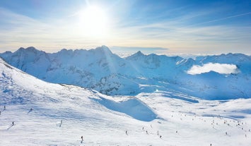 Photo of aerial view of beautiful winter landscape of Les Deux Alpes surrounded by mountains, France.