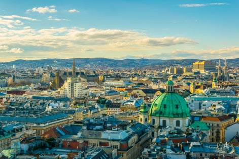 photo of Aerial view of Vienna with tower of the town hall building, votivkirche and peterskirche churches from the stephansdom cathedral, Vienna, Austria.