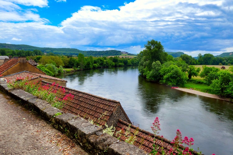 Photo of View of the River Dordogne flowing through the landscape as seen from Beynac et Cazenac a fortified town in the Dordogne, France.