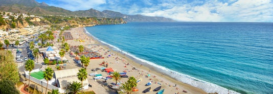 Photo of aerial view of the town of Nerja with the beautiful beach, Málaga, one of the white villages of Andalusia, Spain.