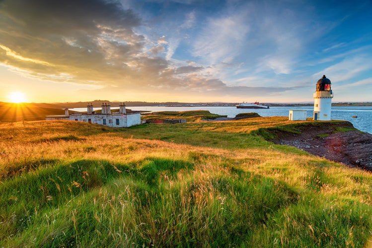 photo of stunning sunset over Arnish Point and it's lighthouse overlooking Stornoway harbor on the Isle of Lewis in the Outer Hebrides of Scotland.