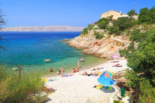 photo of  Pláž Senj it's a small beach hidden by vegetation near the Adriatic Sea, Senj, Croatia.