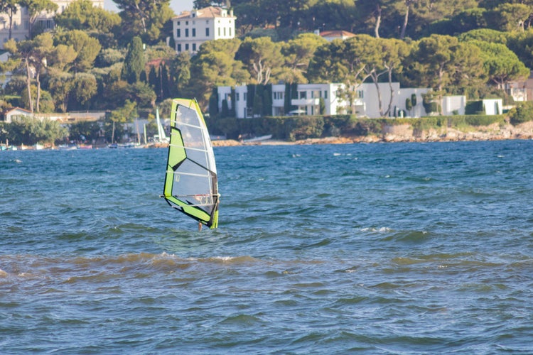 photo of view of Windsurfing, windsurfing in front of the Olivette harbor in Cap d'Antibes, Juan les Pins, Provence, Cote d'Azur, France.