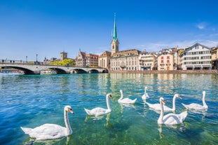 Panoramic view of historic Zurich city center with famous Fraumunster, Grossmunster and St. Peter and river Limmat at Lake Zurich on a sunny day with clouds in summer, Canton of Zurich, Switzerland