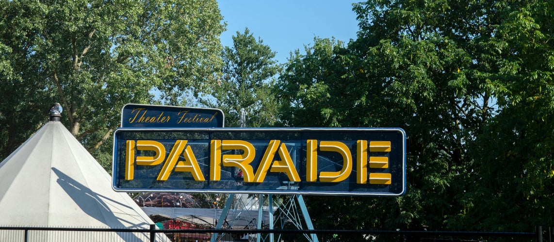 Entrance sign for the Parade Theater Festival in Amsterdam with trees and a blue sky background..jpg