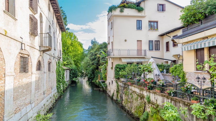 Photo of cityscape of Portogruaro in Veneto Italy with lemene river and houses.