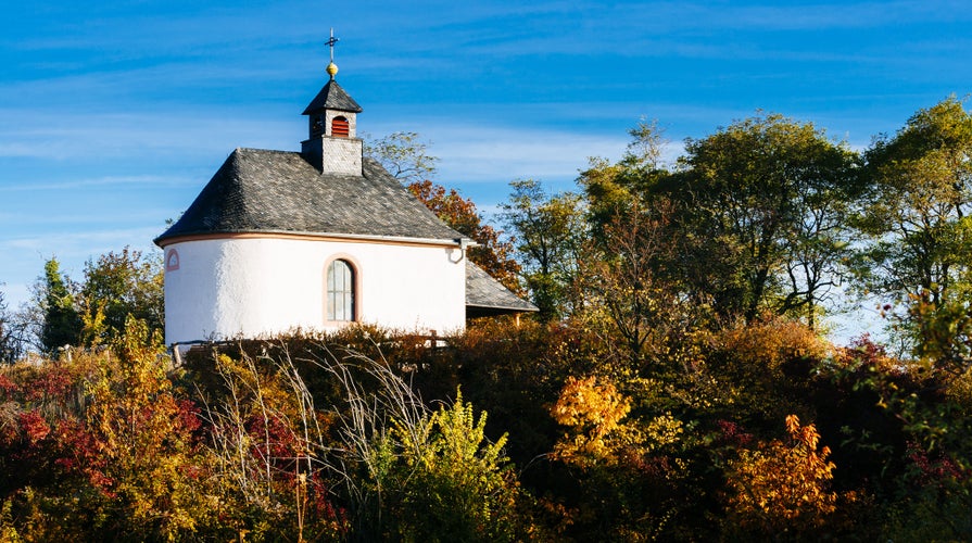 Photo of little white chapel on a hill in autumn/ Ilbesheim, Landau, Rhineland- Palatinate, germany .