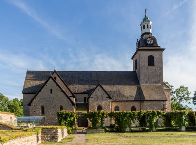 photo of Vreta Klosters Kyrka middle ages church with nice blue sky at Linkoping city, Sweden.