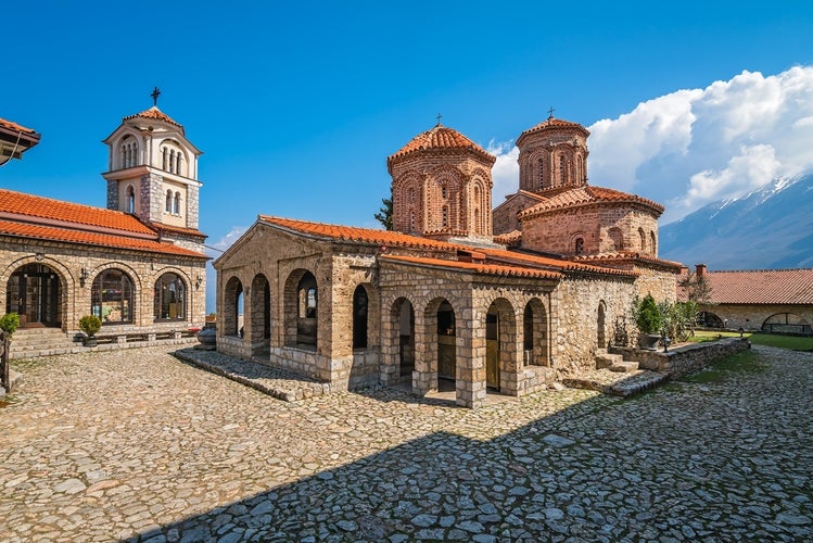 The Saint Naum Monastery in Ohrid, North Macedonia, with its stone architecture and red-tiled roofs under a blue sky..jpg