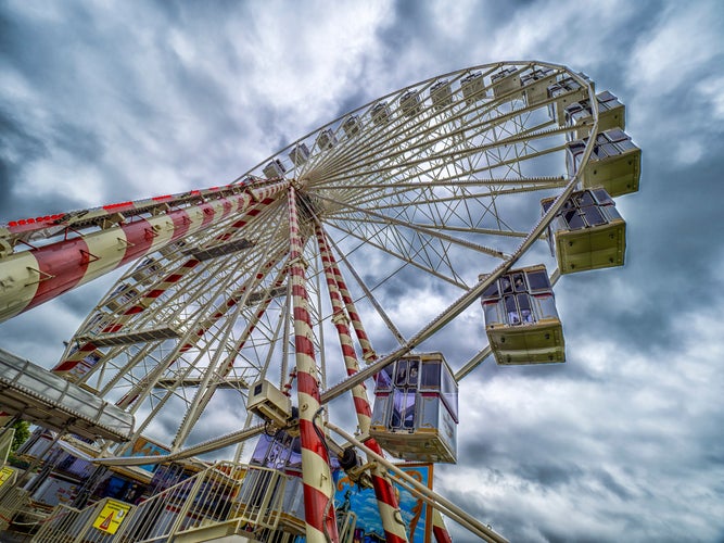 photo of view of Honfleur, France - A low angle view of a Ferris wheel (Grande roue de Honfleur) against a cloudy sky.