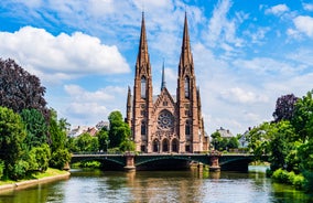 Photo of traditional half-timbered houses on picturesque canals in La Petite France in the medieval fairytale town of Strasbourg, France.