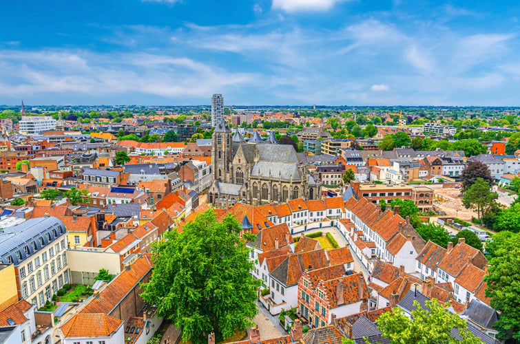 Aerial panoramic view of Kortrijk historical city centre with Roman Catholic Church of Our Lady, Courtrai Begijnhof and red tiled roof buildings, horizon amazing view, West Flanders province, Belgium