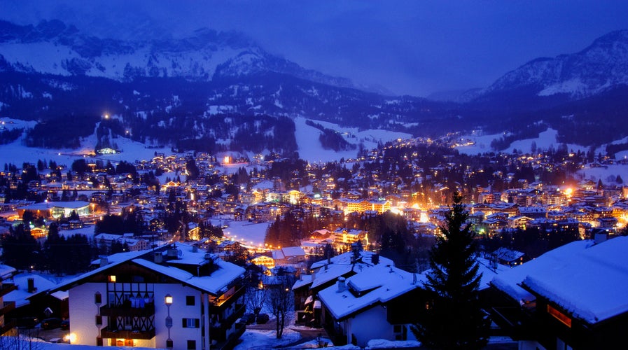 photo of an aerial view of Cortina d'Ampezzo village under the snow on Christmas night, Italy. Concept of magical night, enchanted night, romantic night.