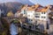 Photo of Capuchin Bridge in Skofja Loka over Selska Sora river, medieval town in Slovenia in autumn time.