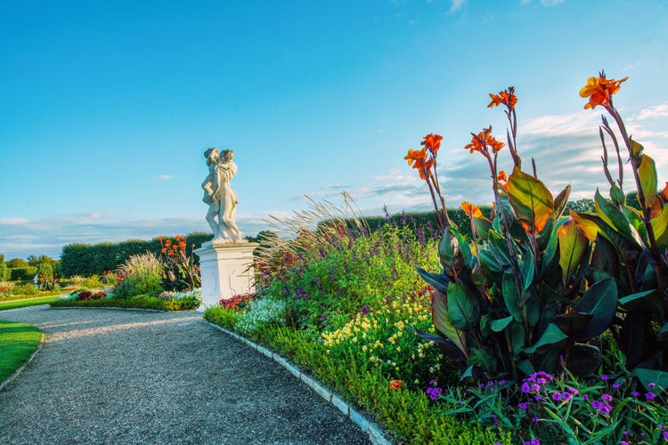 Photo of Beauty of nature of Herrenhausen gardens (baroque style) of Hannover with statue and flowerbeds.