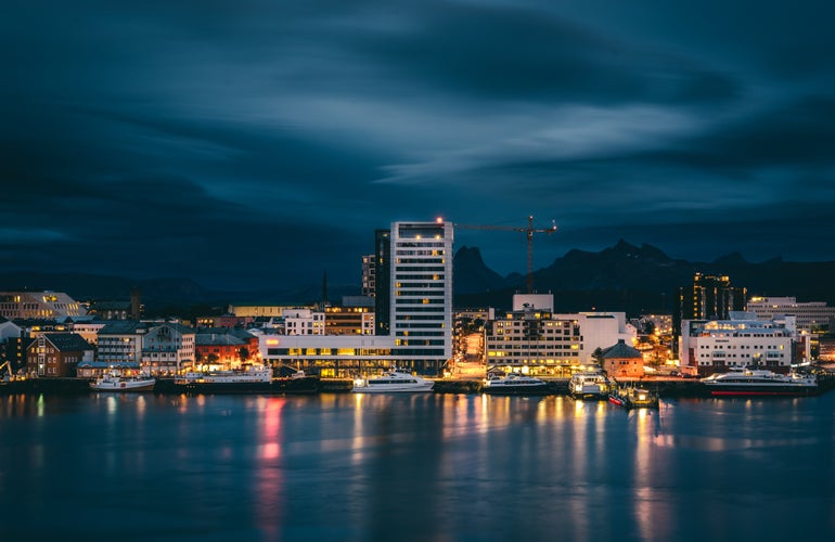 photo of view of A long exposure photograph of Bodø city at night with dramatic clouds