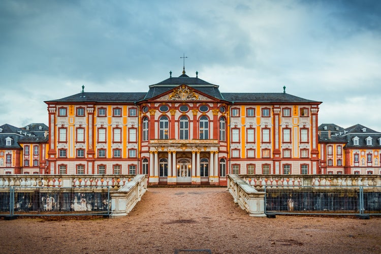 photo  of view of Bruchsal Palace - Baroque castle complex located in Bruchsal, Germany on winter days. Complex including residential building, chapel, pavilions and garden