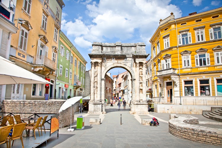 Photo of Golden Roman Gate (Sergius Arch) in Pula at sunny day, Croatia.