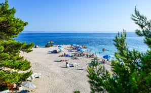 Photo of aerial view on Adriatic Sea and Baska Voda place in Makarska Riviera, Dalmatia region, popular tourist summer resort in Croatia.