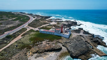 Photo of aerial view over People Crowd Having Fun On Beach And Over Cascais City In Portugal.