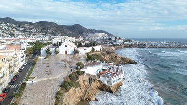 Photo of Sand beach and historical Old Town in mediterranean resort Sitges near Barcelona, Costa Dorada, Catalonia, Spain.