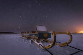 Ii: Snowmobile sleigh trip on frozen sea under starlit sky