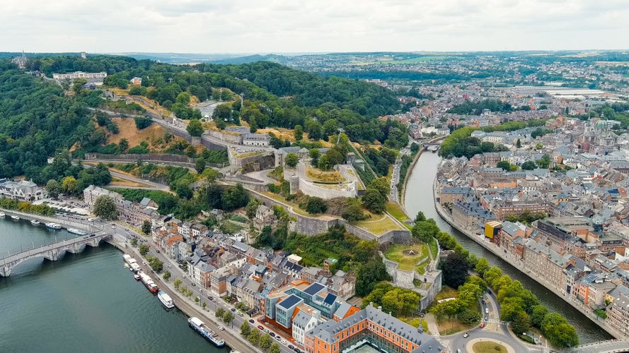 photo of view of Namur, Belgium. Citadelle de Namur - 10th-century fortress with a park, rebuilt several times. Panorama of the central part of the city. River Meuse. Summer day, Aerial View