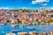 Touristic sightseeing ships in Golden Horn bay of Istanbul and mosque with Sultanahmet district against blue sky and clouds. Istanbul, Turkey during sunny summer day.