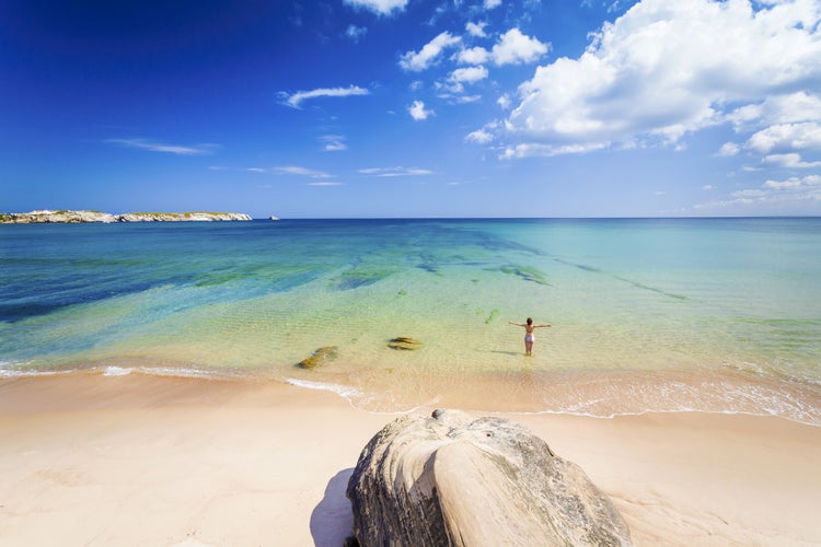 Photo of woman on the beach in Portugal celebrate a wonderful day.