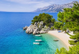 Photo of aerial view on Adriatic Sea and Baska Voda place in Makarska Riviera, Dalmatia region, popular tourist summer resort in Croatia.