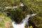 Photo of Cascade falls over mossy rocks under the wooden bridge, Vevcani springs, Jablanica mountain, Macedonia.