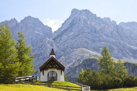 Photo of aerial view of the city of Lermoos, Austria with the Alps mountains in the background on a sunny summer day.