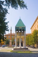 Photo of Italy Piazza Maggiore in Bologna old town tower of town hall with big clock and blue sky on background, antique buildings terracotta galleries.